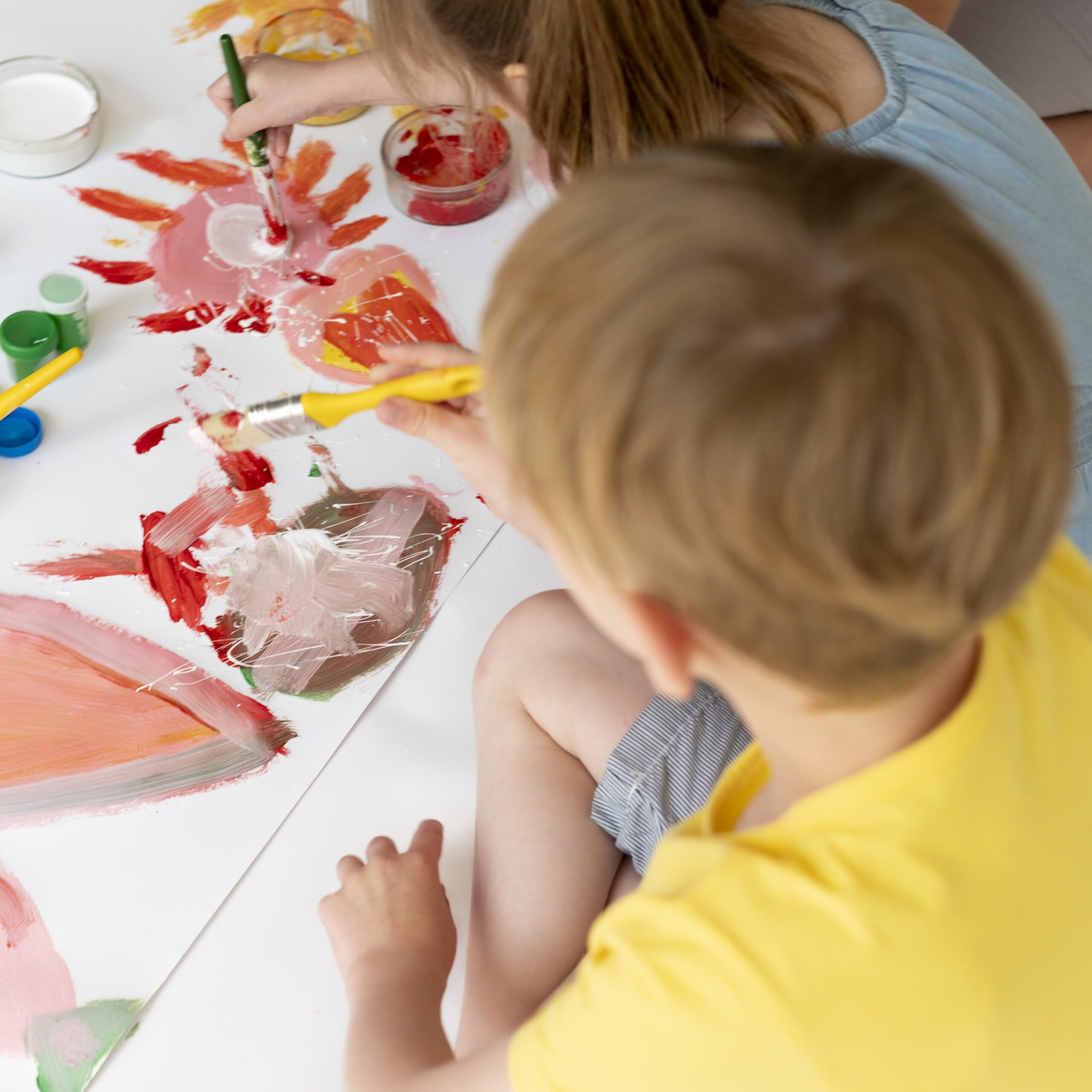 close-up-boy-girl-painting-together